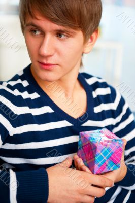 Portrait of young man inside shopping mall sitting relaxed on co