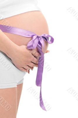 Image of pregnant woman touching her belly with hands