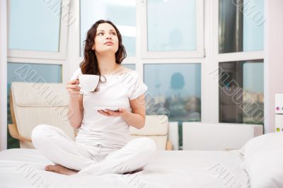 Closeup portrait of a pretty young female having a cup of coffee