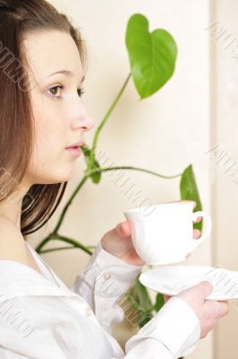 Young woman sitting at the balcony