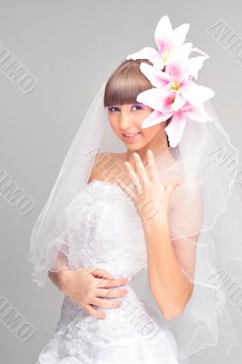 Happy young bride in wedding dress with flower decoration in hai