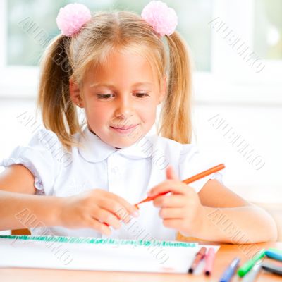 Little girl looking for a drawing concept wile painting picture 