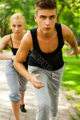Closeup Portrait of Young Couple Jogging In Park