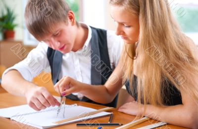 Portrait of college students working indoors looking happy
