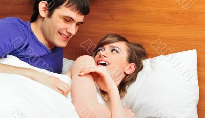 Young man and woman in bed. Couple.