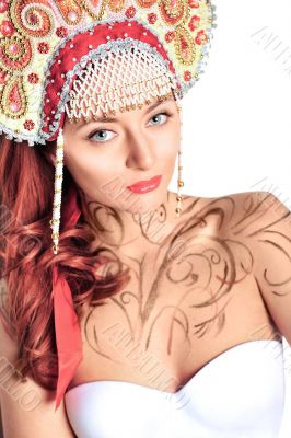 Closeup portrait of pretty young woman with red hairs posing nea