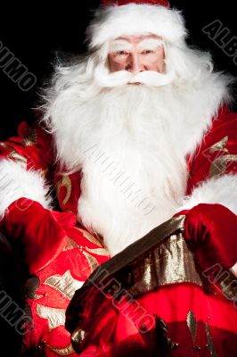 Santa sitting at the Christmas room and looking into the sack