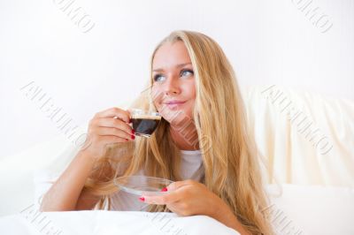 Closeup portrait of a pretty young female having a cup of coffee