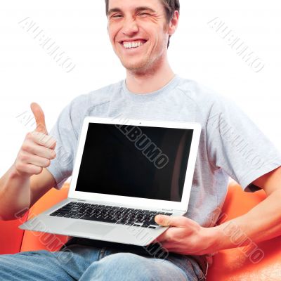 Young man holding his laptop