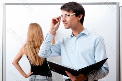 &Ntilde;loseup of adult teacher with student writing on white board at 