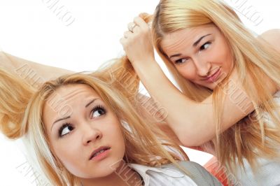 Two women sitting on couch and playing with each other