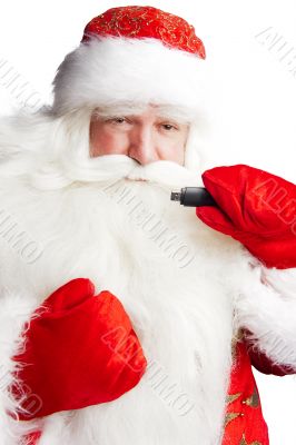 Traditional Santa Claus holding 3g usb modem in his arm on foreg