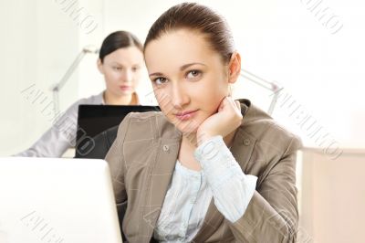Portrait of two women working at their desks