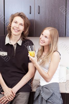 Playful young couple in their kitchen.