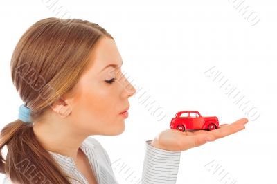 Closeup portrait of young pretty woman holding retro car in her 
