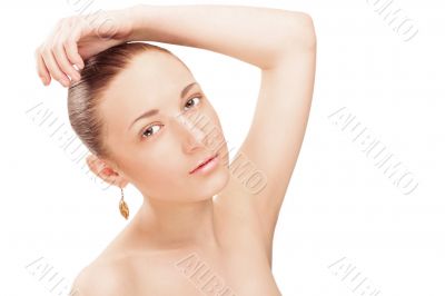 Portrait of a beautiful young woman touching her hair and lookin