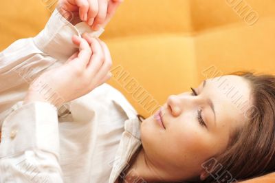 Closeup portrait of young pretty girl laying on her bed