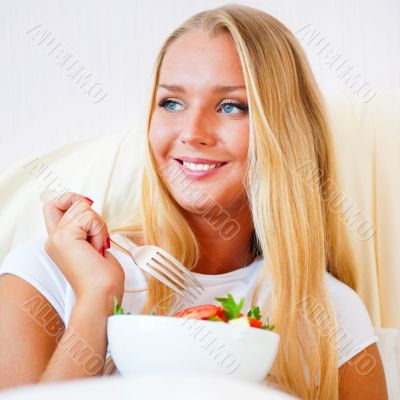 Closeup portrait of a beautiful slender girl eating healthy food