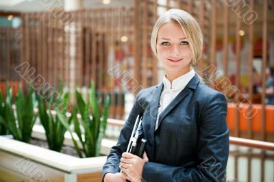 Portrait of a cute business woman with her laptop inside office 