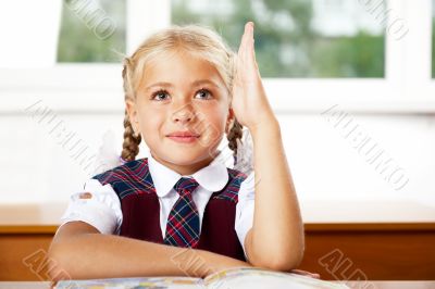 Portrait of a young girl in school at the desk.Horizontal Shot. 