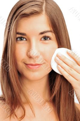 beautiful young brunette woman using cotton pads