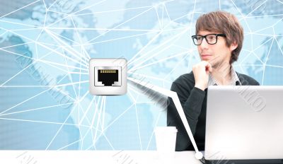 Portrait of happy young business man using her laptop. World map