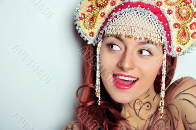 Closeup portrait of young beautiful woman wearing russian tradit