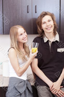Playful young couple in their kitchen.
