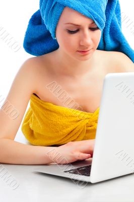 young beautiful smiling woman prints on the laptop - indoors