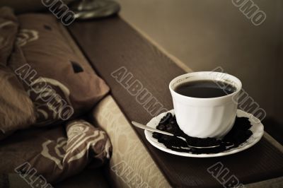 warm cup of coffee on brown background