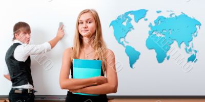 Portrait of two students making presentation in glassroom near w