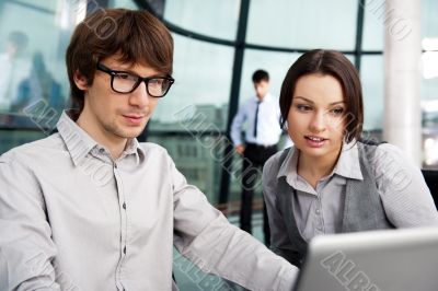 Portrait of confident business man explaining a project to colle