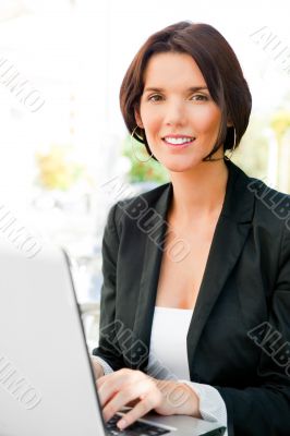 Young business woman on a laptop using wireless internet connect