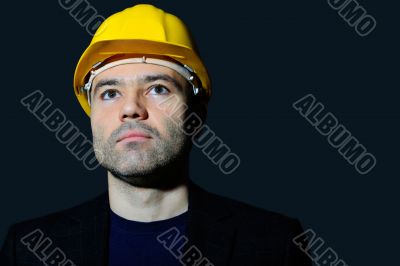 Closeup portrait of mature man wearing helmet looking far 
