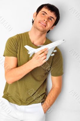 Closeup portrait of handsome caucasian man holding aircraft at h
