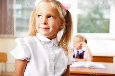 Portrait of a schoolgirl being in a classroom at school with her