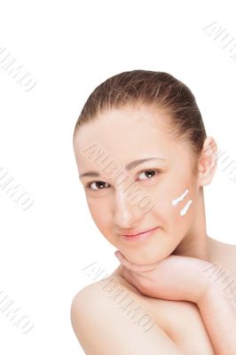 Portrait of a beautiful young woman with two lines of cream on h