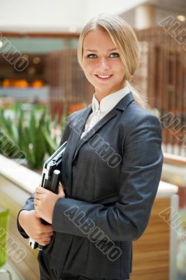 Portrait of a cute business woman with her laptop inside office 