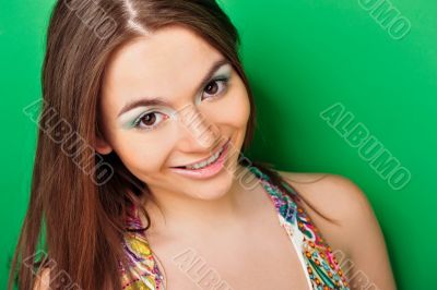 Closeup portrait of excited woman on green background.