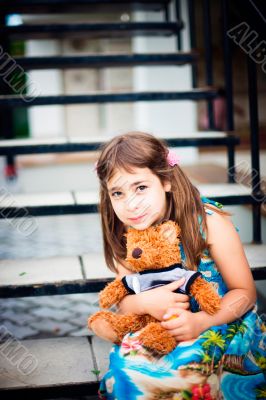 Artistic lifestyle photo of cute little girl outdoor sitting at 