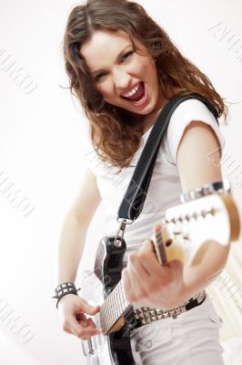 Portrait of beautiful young and attractive womanplaying her guit