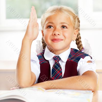Image of smart child reading interesting book in classroom. Vert
