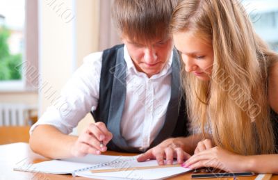 Portrait of college students working indoors looking happy