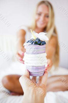 Boyfriend making a gift to his girlfriend in the morning. She is