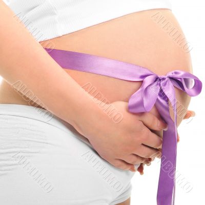 Image of pregnant woman touching her belly with hands