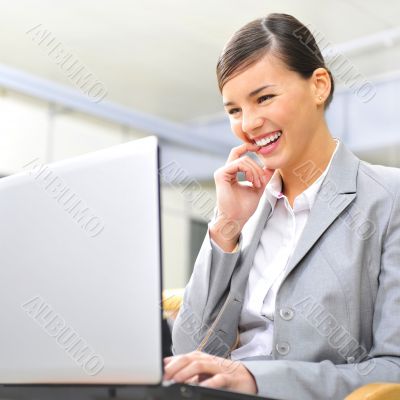Beautiful business woman dreaming while working on computer at h