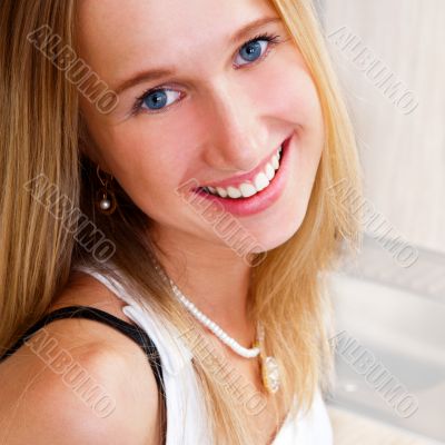 Portrait of beautiful relaxed young woman standing at the kitche