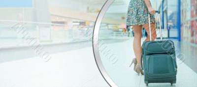 Woman`s legs and travel suitcase at international airport tax fr