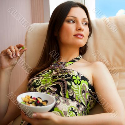 Portrait of smiling beautiful young brunette woman at home