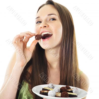 beautiful woman biting a bar of chocolate in a sexy way